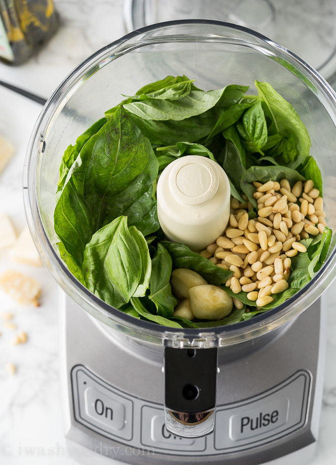 This is the EASIEST Fresh Basil Pesto Recipe! Just combine the ingredients in a food processor and watch the magic happen!