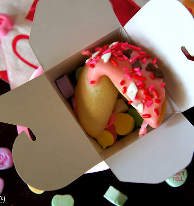 A Valentine Fortune Cookie displayed in a gift box with candied hearts