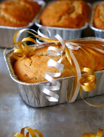 A small loaf of Eggnog Bread wrapped with a ribbon