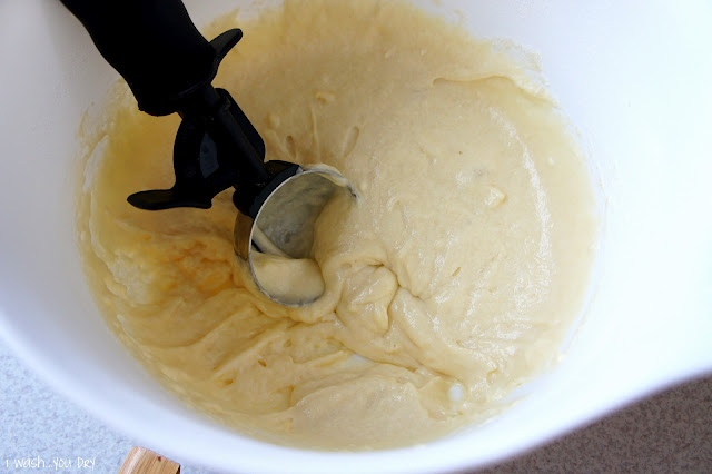 A scooper in a bowl of donut dough