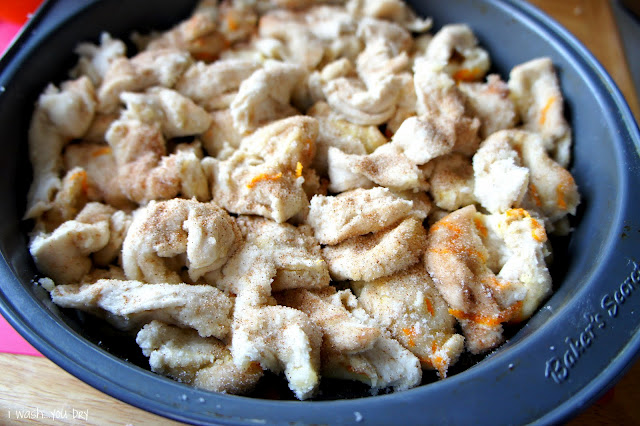 A close up of Baked Orange Cinnamon Pull Aparts in a round baking pan