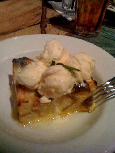 A bowl of cake topped with ice cream. 