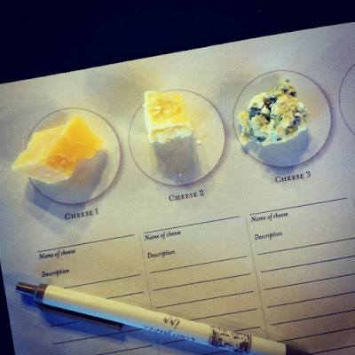 A paper with 3 different types of cheese samples and space to write the cheese name and descriptions below each