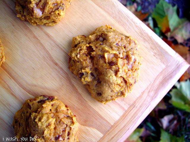 Cookies spaced out on a cutting board. 