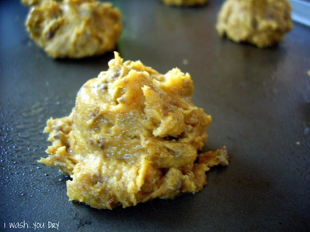 Balls of cookie batter on a baking sheet. 