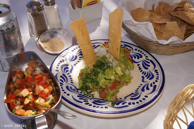 Guacamole on a plate with two large chips in it. 