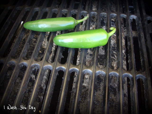 Two jalapeños on a grill.