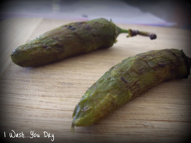 Two Jalapeños on a cutting board. 