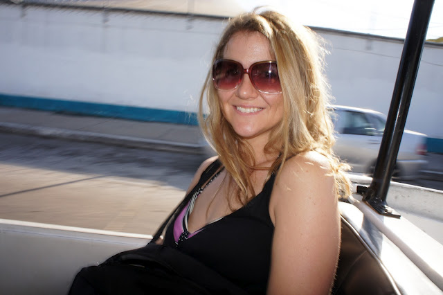 A woman wearing glasses and smiling at the camera