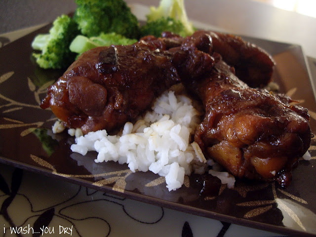 Chicken wings displayed on a plate with rice. 