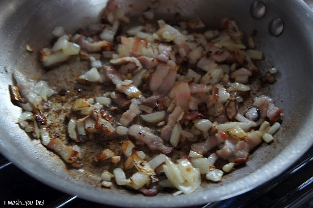 Chopped potatoes, onions and meat cooking in a skillet.