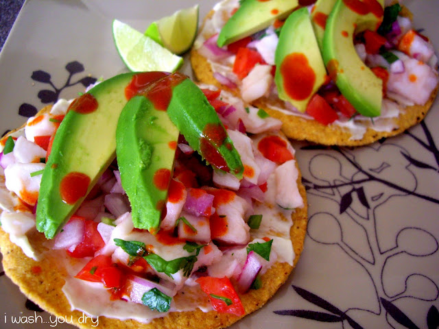 Slices of avocado on top of veggies and a small tortilla. 