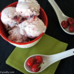 A close up of a bowl with scoops of Dark Chocolate Covered Cherry Frozen Yogurt