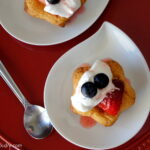 Strawberry Shortcake Cookies topped with whipped cream displayed on a plate.