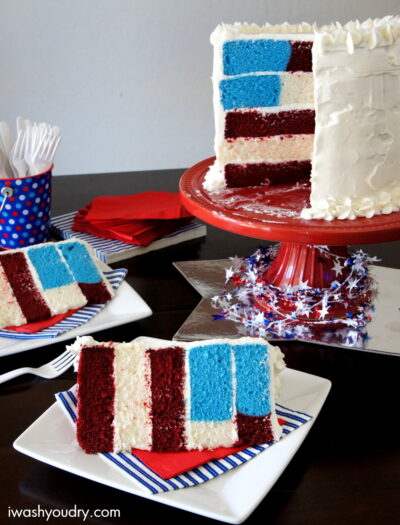 A cake sitting on top of a table with slices missing and two slices of cake on plates in front of it