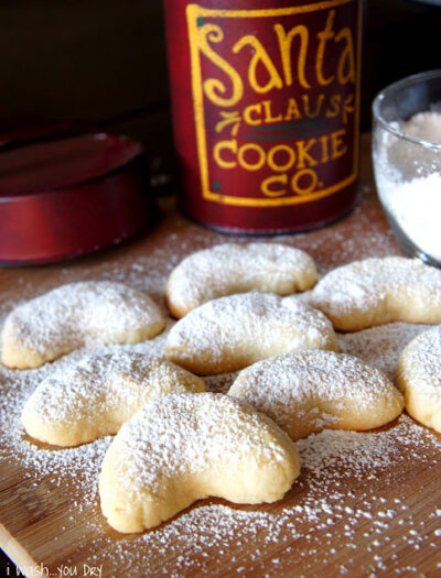 A close up of powdered Almond Crescent Cookies