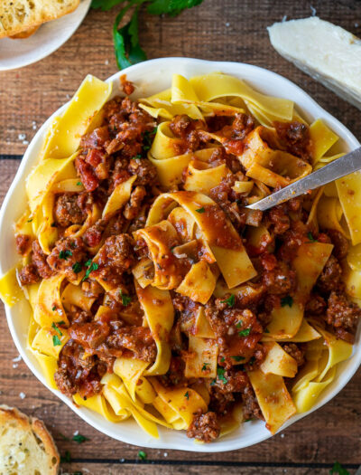 A plate of pasta sauce and noodles on a table