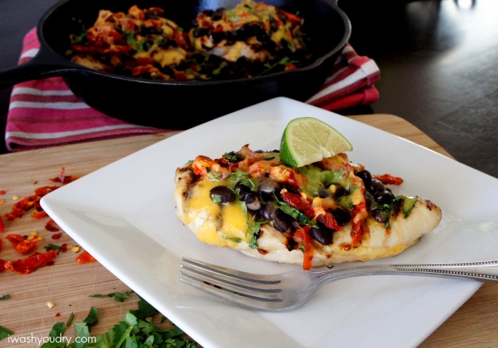 Zesty Grilled Santa Fe Chicken on a plate on a table next to a pan with more chicken