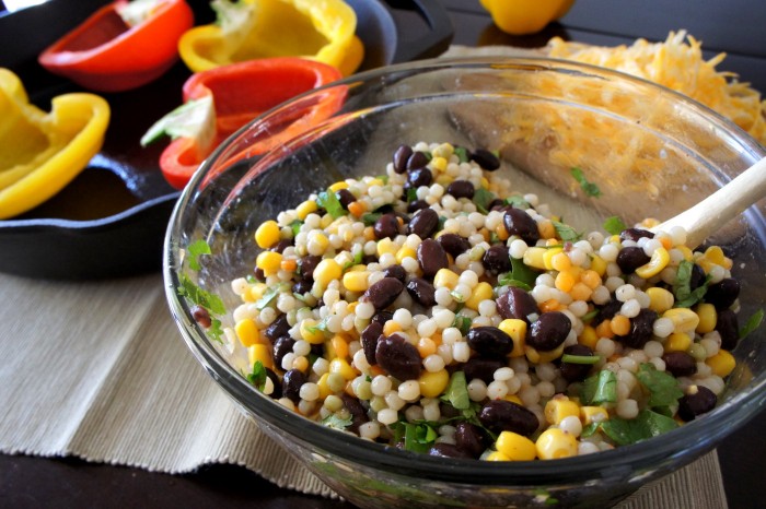 Couscous and beans mixed together in a glass bowl. 