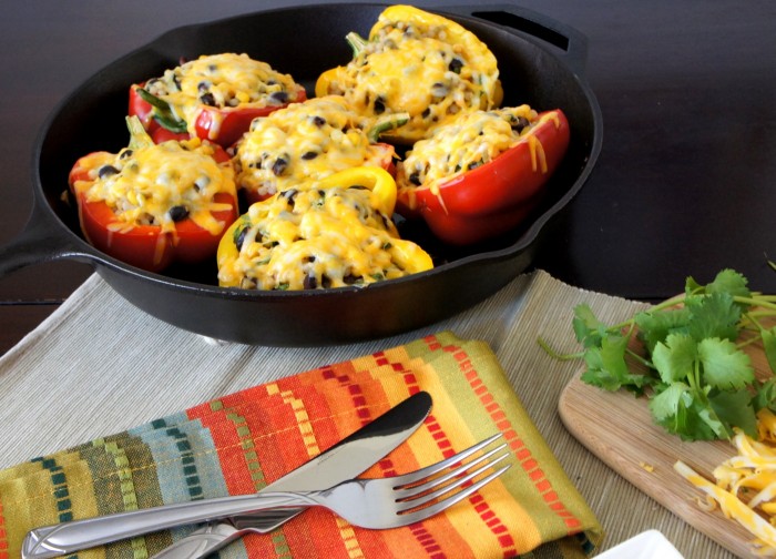 Stuffed peppers in a skillet displayed on a table 