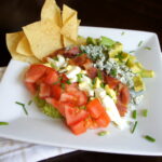 A plate showcasing Cobbocado Guacamole with a side of chips