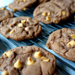 Chocolate cookies with peanut butter chips on a cooling rack