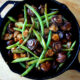 Chicken, mushrooms and green beans in a skillet.