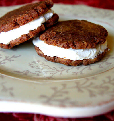 Two cookie sandwiches displayed on a plate