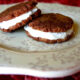 Two cookie sandwiches displayed on a plate