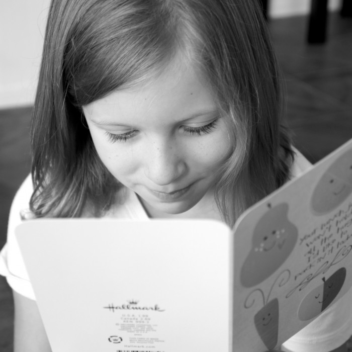 A girl looking at a greeting card