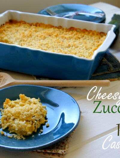 A scoop of casserole on a plate in front of a pan of Cheesy Zucchini and Potato Casserole