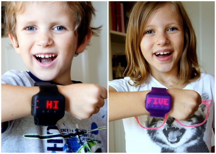 A boy and girl demonstrating the words on a Text Band