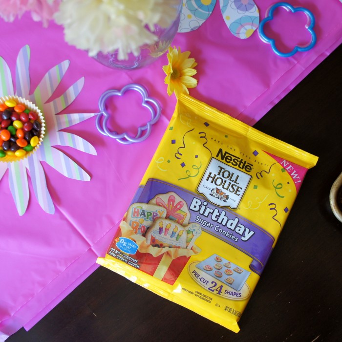 A package of raw Toll House Birthday Sugar Cookies on a table surrounded by birthday party table decor