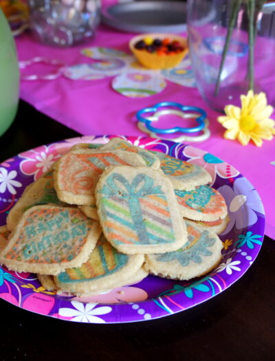 A plate of sugar cookies on a party plate