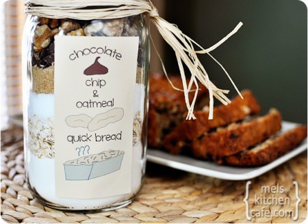 Oatmeal Chocolate Chip Quick Bread in a large mason jar in front of a sliced baked loaf of bread behind it 