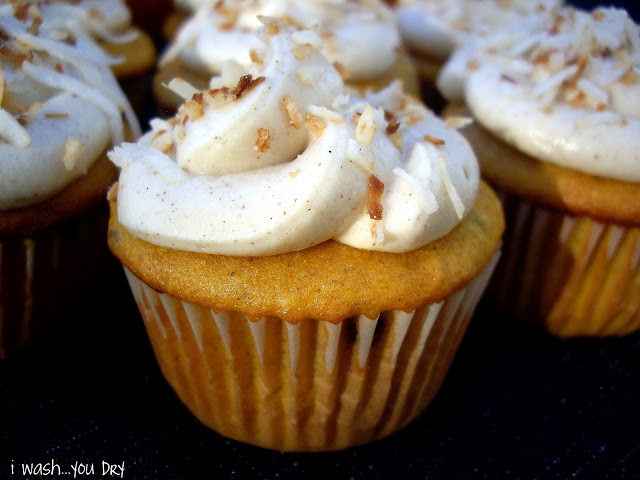 A close up of a cupcake with a swirl of white frosting on top