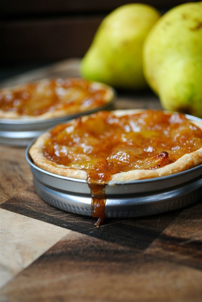 Mini Pear Tarts made in mason jar lids displayed on a table 