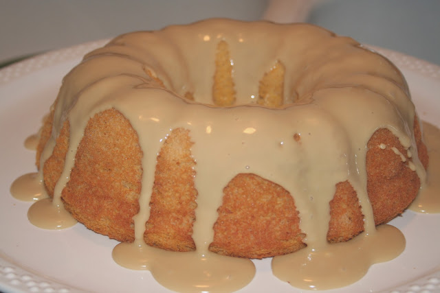 A bunt cake with frosting on it