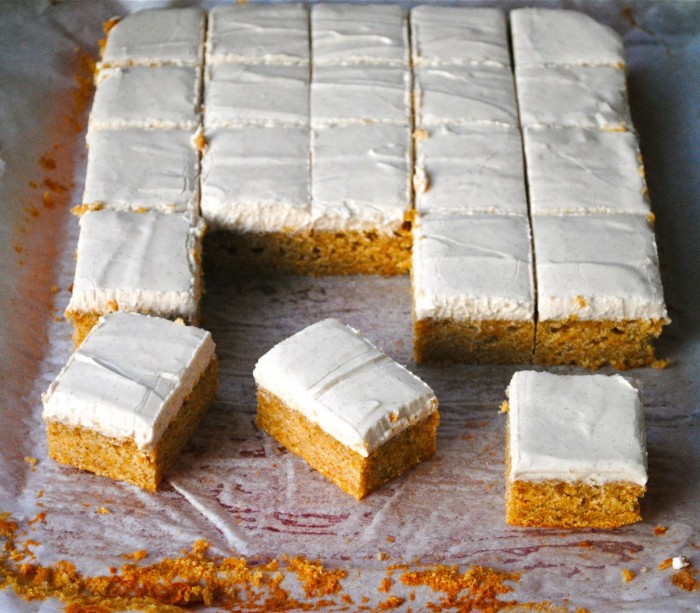 A cake cut into squares with some of the pieces removed from it