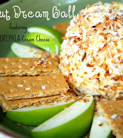 A close up of a Coconut Dream Ball surrounded by graham crackers and green apple slices