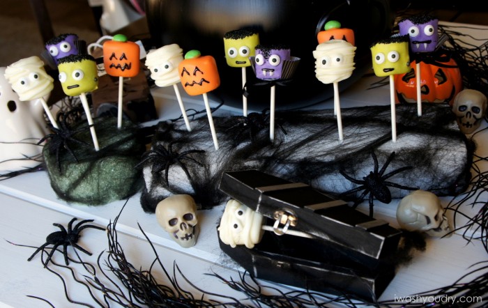 A display of Halloween themed marshmallow pops - mummy, pumpkin, Frankenstein and a vampire