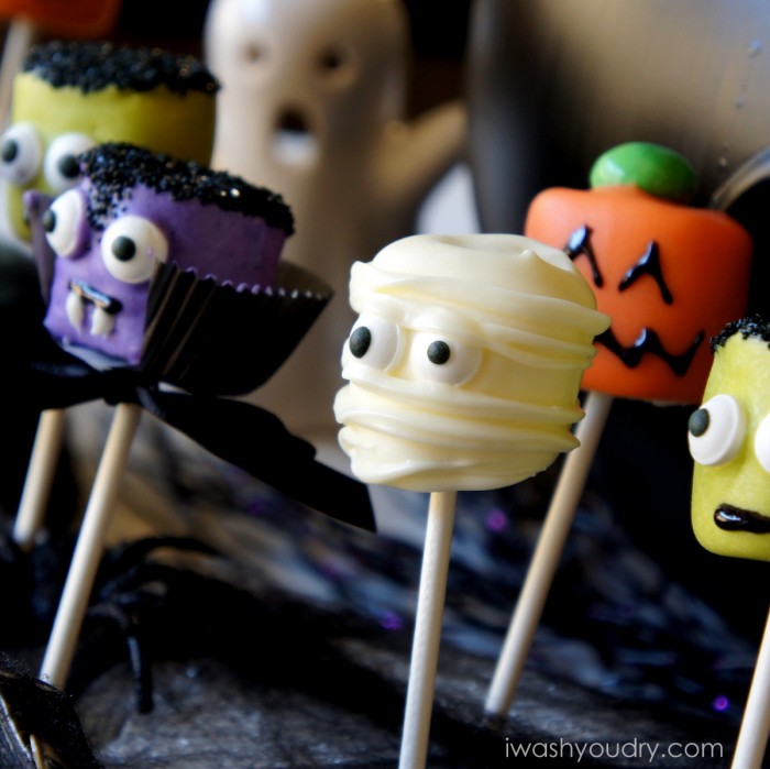 A close up view of Halloween themed Marshmallow pops - a mummy, a pumpkin, Frankenstein and a vampire