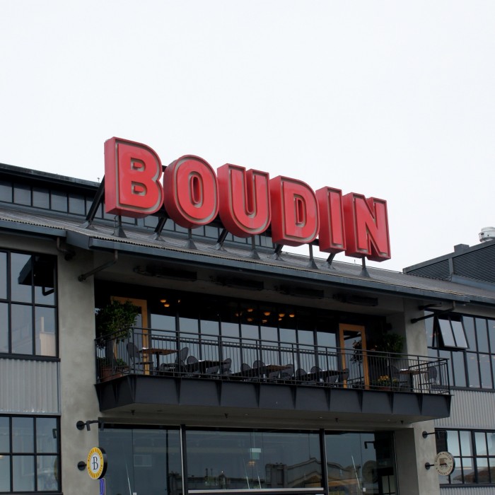 A sign on a building in San Fransisco saying \"Boudin\"