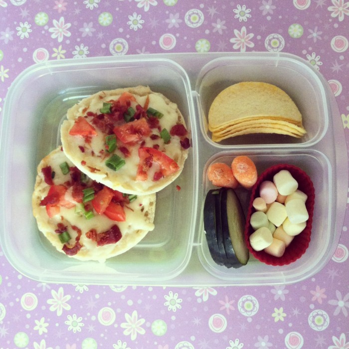 A plastic bento container filled with different types of foods for lunch