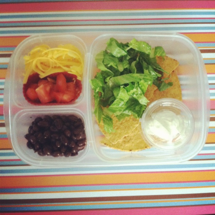 A close up of a bento styled plastic container with an easy lunch example 