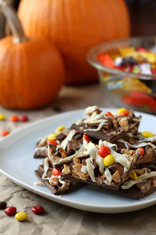 A close up of a plate with stacked pieces of Halloween Candy Bark 