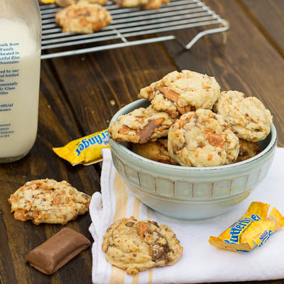 A bowl of cookies on a table that are made with Butterfinger Halloween Candy