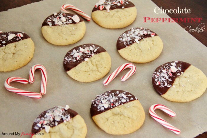 A pan of sugar cookies half dipped in chocolate and crushed peppermint