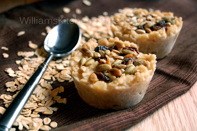 A close up of a mini tart on a wooden surface with oats around it