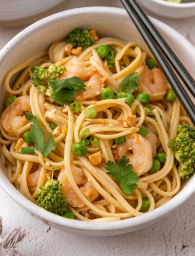 white bowl with noodles and shrimp.